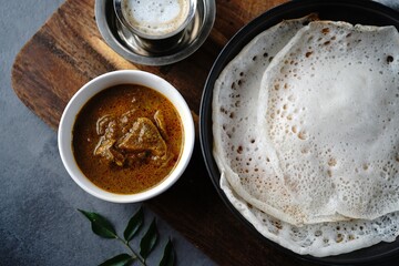 Kerala breakfast appam or palappam with mutton curry