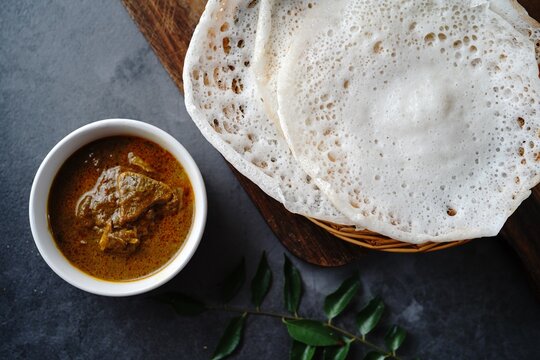 Kerala breakfast appam or palappam with mutton curry