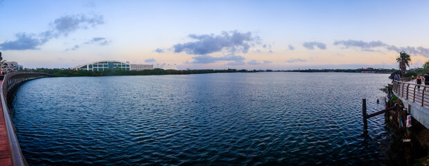 panoramic of lagoon with buildings in the background, sunset in the sky with soft colors, carpenter´´'s lagoon in tampico tamaulipas 