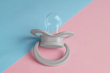 New baby pacifier on color background, closeup