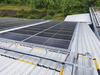 Photovoltaic solar panels mounted on building roof for producing clean ecological electricity at...