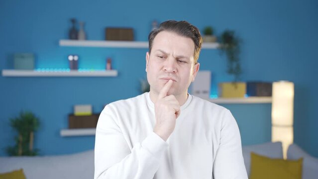 Man thinking of new creative and genius ideas at home.
The man who comes up with an ingenious and creative idea is happy and proud of himself.
