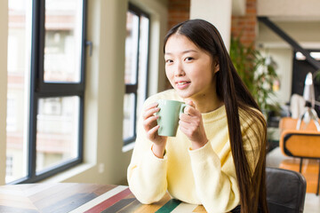 asian pretty woman with a coffee cup at cool home