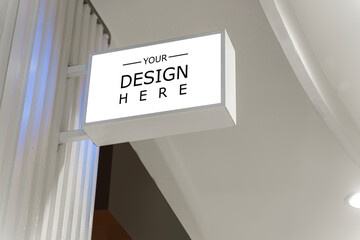 White signage mockup on a wall. Mockup sign outside of a shop. White Square Sign With Blank Space - obrazy, fototapety, plakaty