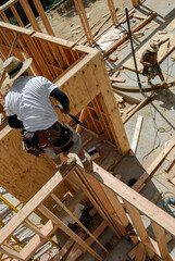 Carpenter crew framing walls, high angle view