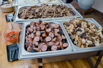 buffet with meat, chicken and roasted sausage