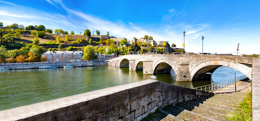 The stone arches of the bridge of Jambes over the Meuse at the foot of the hill of the Citadel of...
