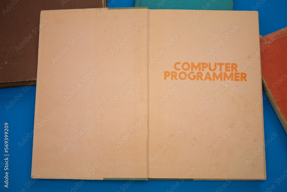 Poster computer programmer word in opened book with vintage, natural patterns old antique paper design.
