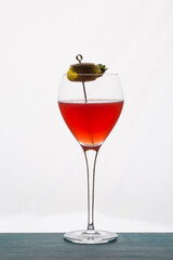 Refreshing tropical boozy cocktail with lemon juice on white background