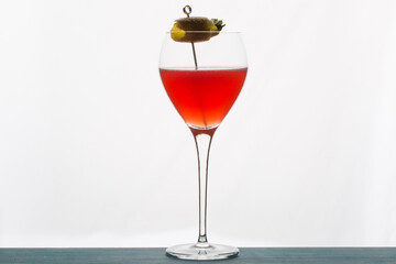 Refreshing tropical boozy cocktail with lemon juice on white background