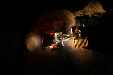 Night Large quarry dump truck. Big yellow mining truck at work site. Loading coal into body truck...