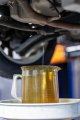 Change engine oil at an auto differential maintenance shop.