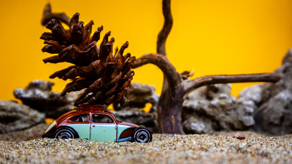 toy car hauling pinecones on an orange background
