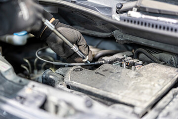 Change spark plugs at an auto-differential service shop.