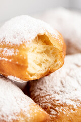 close up of a beignet with a bite with sugar