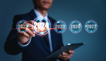 Happy new year 2024 hand touch on a virtual screen 2024. New Goals, Plans, and numbers for Next Year. Businessman touching future growth year 2023 to 2024. Planning, opportunity, business strategy