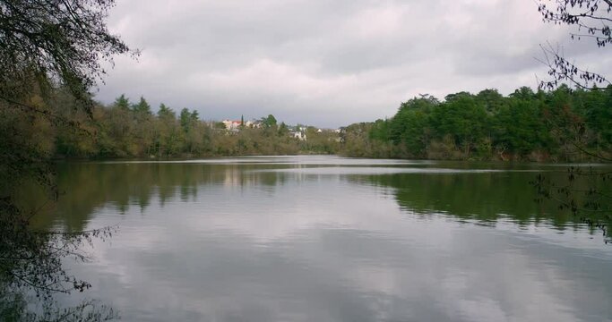 Calm Lake With Mirror Reflections In Angers, France During Cloudy Day. Wide Shot