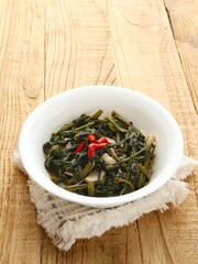 Tumis Kangkung, Ca Kangkung, Indonesian food. Served on white bowl.
