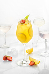 Classic cocktail in glass on white background with lime, mandarins, soda, alcohol and lemon
