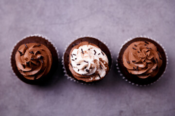 Delicious chocolate cupcakes on gray background