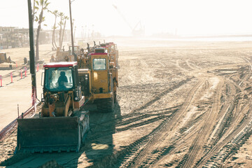 Heavy machinery bulldozer on beach sand
