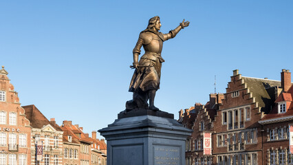 Architectural detail of the Grand-Place, the main square and the centre of activity of Tournai, Hainaut, Belgium. In the foreground, the Princess of Epinoy statue