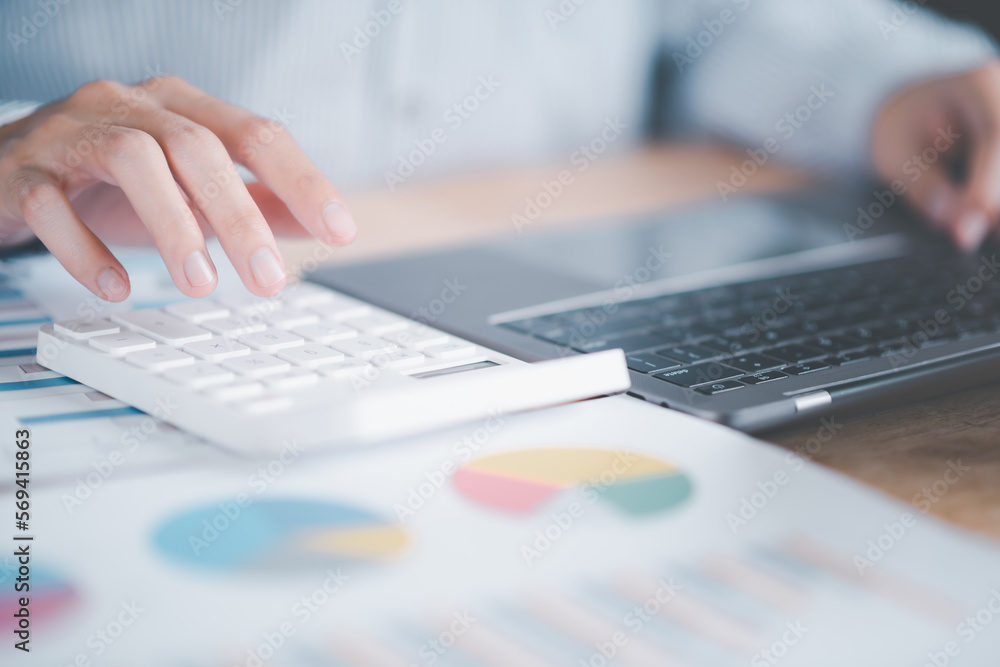 Poster accountant calculating figures in company financial documents with a calculator,analysis of company 