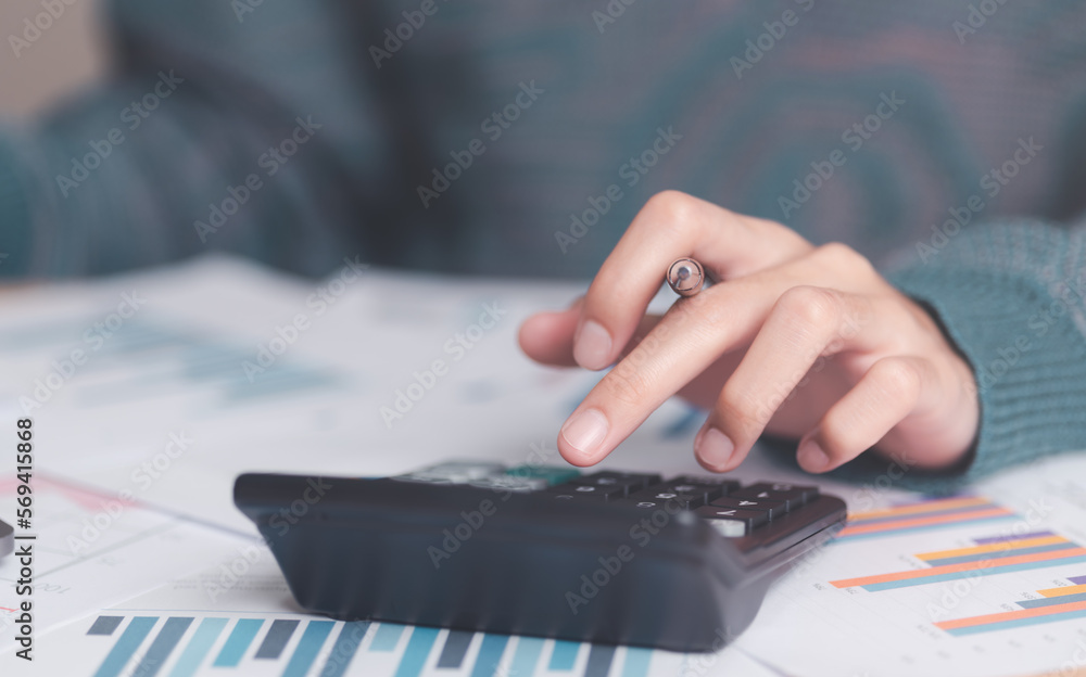 Poster businessman calculating figures in company financial documents with a calculator,analysis of company