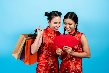 portrait, Two Asian girls  wearing cheongsam on chinese new year, In his hand was full red...