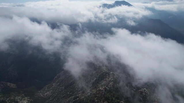 AERIAL drone over misty clouds and mountains, mystical nature of Turkey, thermessos, antalya