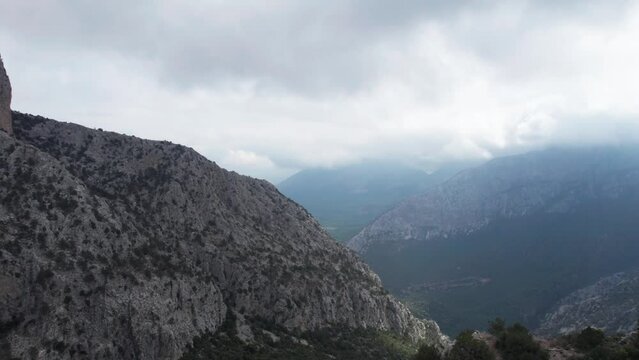 AERIAL - Epic shot over the ancient walls of Termessos, Turkey, forward spinning shot