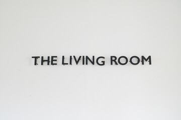 living roomsign on wall in living room.