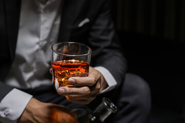 Closeup businessmen holding a glass of whiskey