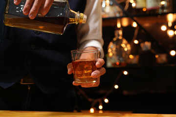 Bartender pouring Whiskey, on  bar