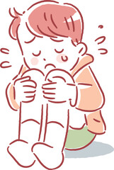 涙を流しながら膝を抱えてなく男の子