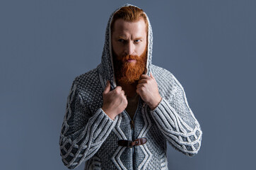 photo of unshaven brutal man in winter fashion. brutal man in winter fashion isolated on grey.