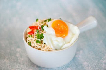 instant noodles cooking tasty eating with bowl, noodles bowl with boiled egg vegetable spring onion and chili on table food, noodle soup