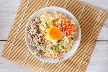noodles plate with egg minced pork vegetable spring onion celery and chili on table food , instant noodles cooking tasty eating with bowl noodle