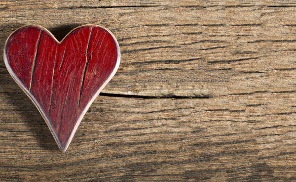 valentine day heart shape on wooden background, old wooden red heart
