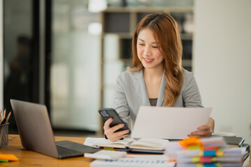 businesswoman holding coffee cup talking on the phone. Happy to work.