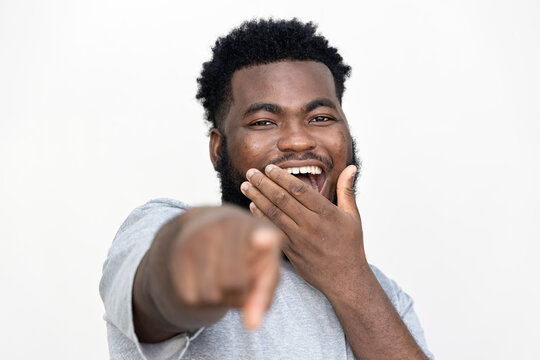 Young African man laughing at you