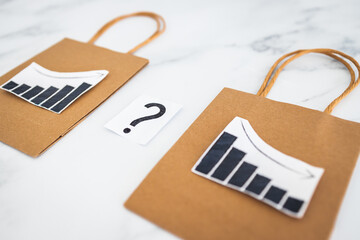when will inflation go down. shopping bags with graph showing prices increasing then dropping with...