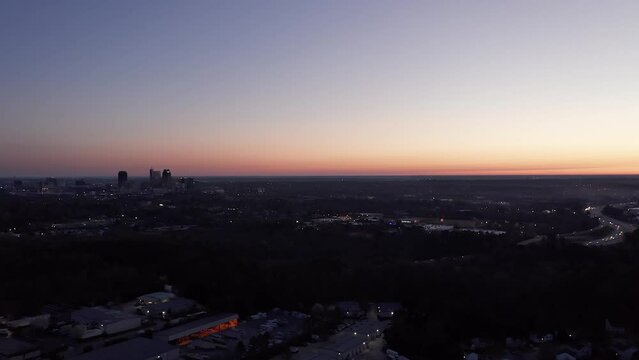 Aerial shot of sunset over American city. Beautiful establishing shot at night.
