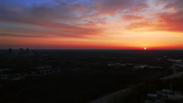 Aerial view of sunset over Raleigh North Carolina. Beautiful golden hour America establishing shot by drone.
