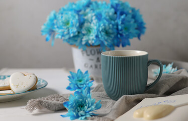 Still life with blue asters and a cup