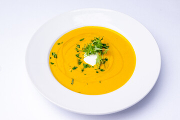 Pumpkin soup with cream and herbs