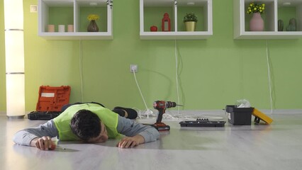 Repairman young man faints, work accident. Injury at work.
The young man, who does not take occupational safety precautions, faints, gets electrocuted, and has a work accident.
