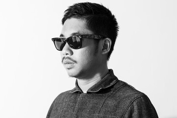 Asian man wearing sunglasses on white background.