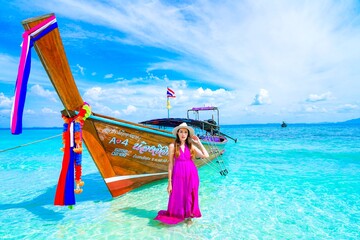 woman with a pink dress on the beach in krabi thailand, chicken island, tup island, photo shooting,...