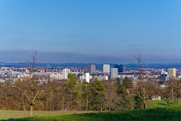 Scenic landscape with skyline of City of Wallisellen in the background seen from City of Zürich district Schwamendingen on a sunny winter day. Photo taken February 7th, 2023, Zurich, Switzerland.